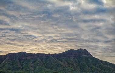Fototapeta premium Clouds over a Mountain at Sunrise.