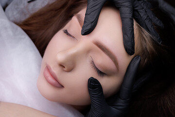 Close-up demonstration of permanent makeup after eyebrow design procedure. PMU Procedure, Permanent...