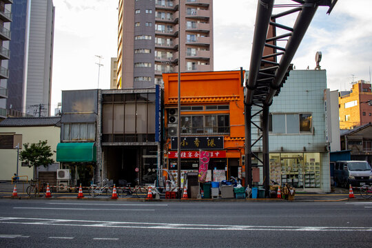 Tokyo, Japan, October 25, 2023: Contrast of Traditional Shops and Modern Construction in Tokyo.