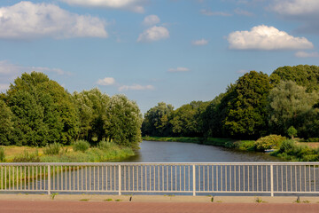 Fototapeta na wymiar The Vecht (Vechte) in Ommen, The Dutch provinces of Overijssel, To avoid confusion with its Utrecht counterpart is a river in Germany and the Netherlands, Water system and management in Holland.