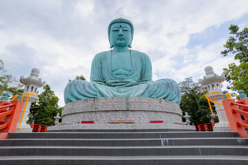 The great Buddha of Kamakura statue with blue sky as background, Buddhist temple houses the...