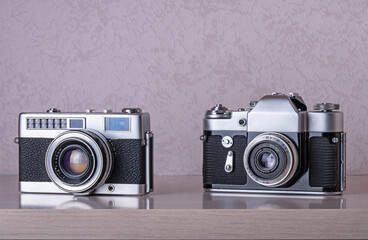 Vintage SLR cameras on wooden shelf