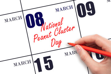 March 8. Hand writing text National Peanut Cluster Day on calendar date. Save the date.
