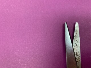 scissors on a purple background Taken from the paper surface
