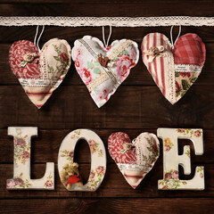 Square shape wooden background with handmade hearts and diy LOVE letters