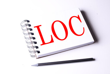 Text LOC on notebook on the white background, business