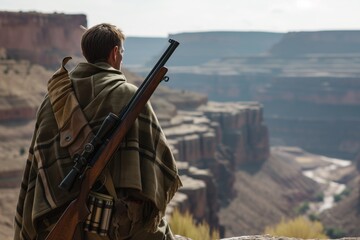 man in a poncho with a rifle looking out over a canyon
