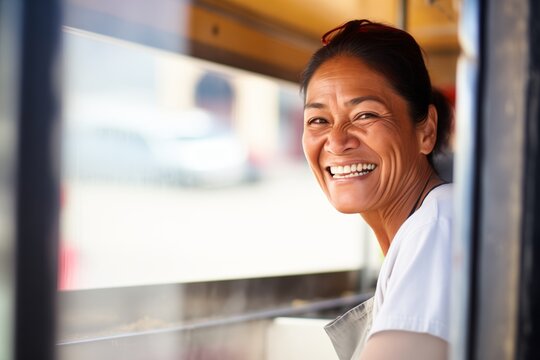 customers point of view of a smiling woman at a pizza truck window