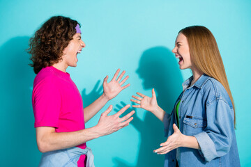 Side profile photo of young sister and brother teen age has conflict dialogue screaming at each...