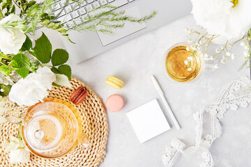 Open note mock up, herbal tea and laptop. Freelance, to do list, shopping list concept. Aesthetic tea time, feminine meditative lifestyle, cozy home. Copy space