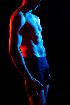 Handsome bodybuldier man posing showing muscle, shirtless torso showing pectorals and sixpack