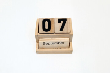 7th of September wooden perpetual calendar. Shot close up isolated on a white background