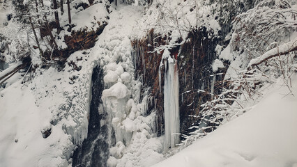 Huk waterfall, frozen waterfall at winter, Carpathian National Park. Ukraine.  - obrazy, fototapety, plakaty