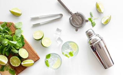 Alcoholic drink mojito making in blender with mint and lime, top view