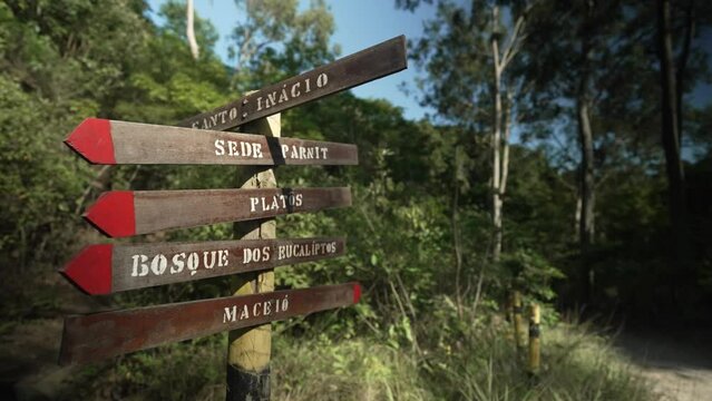 Signposts on a hiking trail surrounded by trees and Atlantic Forest vegetation, within the protected area Parque Municipal da Cidade, in Niter&oacute;i, Rio de Janeiro, Brazil