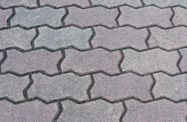 Obraz premium Texture of cobblestone. Pattern of sidewalk tiles in the street. Cobblestones close up.