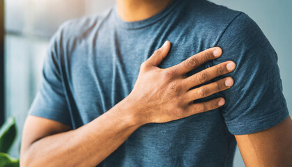 hand over chest, depicting heart attack pain, against a clean background, emphasizing health concern