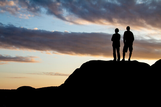 silhouette of people on the top of mountain
