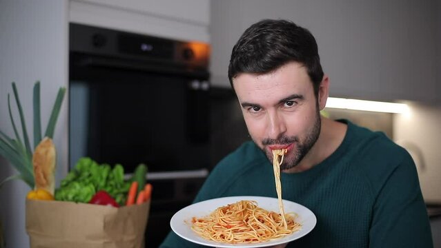 Funny man absorbing some spaghetti