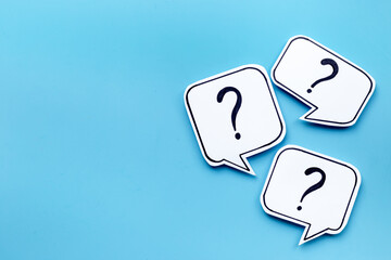 Ask and answer concept. Question marks on speech bubbles, top view