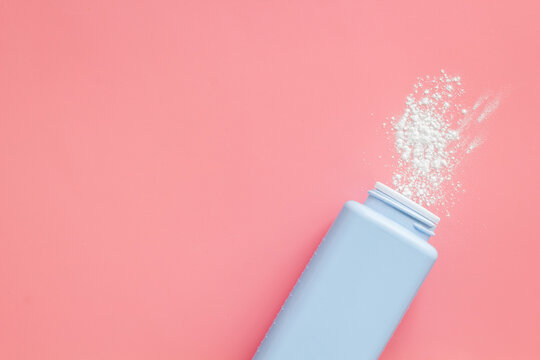 Spilled baby talcum powder. Container with powder for baby body care
