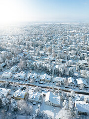 Fototapeta na wymiar Snow-covered suburban houses seen from above