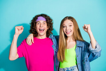 Portrait of two best friends teamwork concept teenagers raised fists up at hipster party...