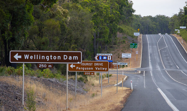 lots of road signs on side of highway at the Wellington Dam turn off