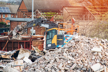Demolition of building. Excavator breaks old house. Making space for the construction of a new...