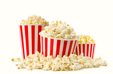 Popcorn buckets in a big pile of popcorn isolated on white background