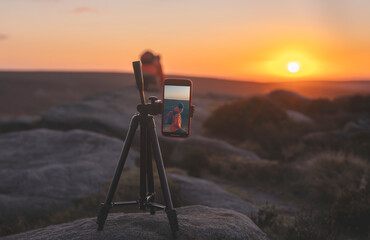 phone on a tripod taking photos or video of a landscape at sunrise  or sunset in Peak District