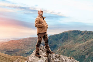 Deurstickers Bearded Man reaching the destination  and on the top of mountain  at sunset on autumn day  Travel  Lifestyle concept The national park Lake District in England © Iryna