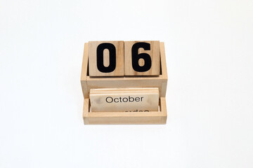 6th of October wooden perpetual calendar. Shot close up isolated on a white background