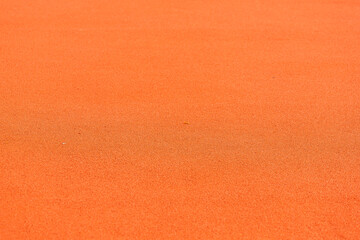 Close-up of orange rubber running surface on court texture