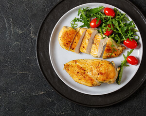 fried chicken breasts with green salad on plate