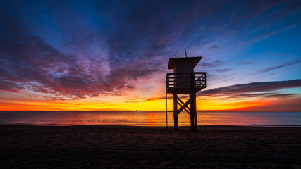 Fototapeta na wymiar the lifeguard tower on the beach at sunrise in Vera Playa