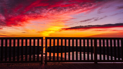 Fototapeta na wymiar Sunrise at the beach seen from the new bridge over the laguna