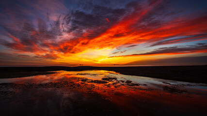 A rich colourful sunrise over the laguna at Vera Playa, Almeria, Spain