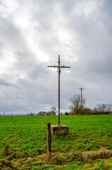 Rural landscape with a crucifix in the French Ardennes
