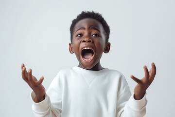 A joyful young boy expressing surprise