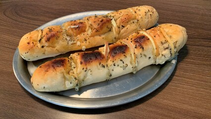 Baked garlic bread. Tradicional food from Brazilian cuisine filled with cheese. Commonly served in a barbecue.