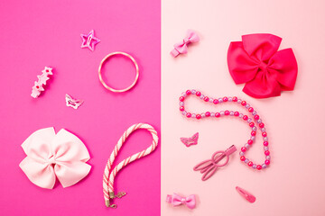 Little girls accessories on a pink background, flat lay