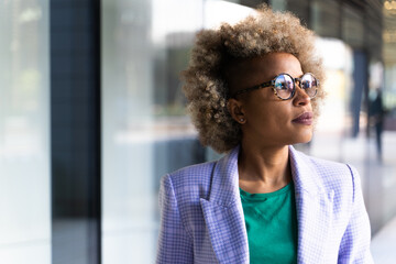 Young professional woman looking inspired at her workplace