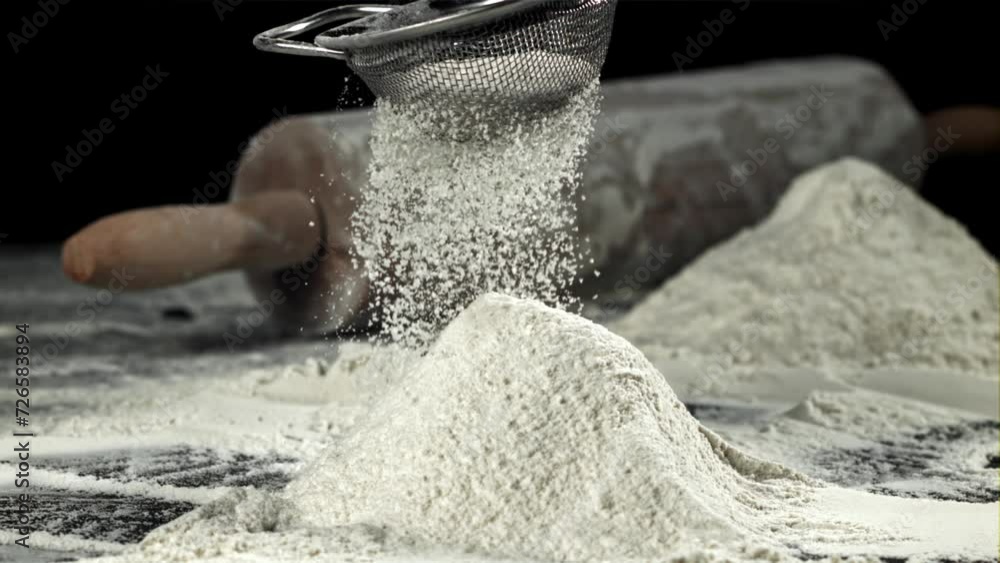 Sticker The flour is sifted onto a mound with flour. Filmed on a high-speed camera at 1000 fps. High quality FullHD footage