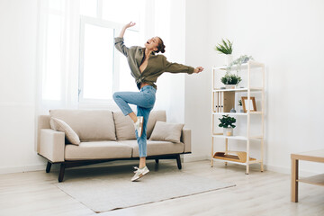Playful Woman Jumping for Joy in a Cozy Apartment