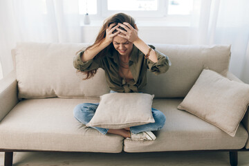 Obraz premium Lonely Woman on Couch, Feeling Sad and Worried in a Home Setting