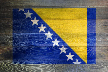 Bosnia Herzegovina flag on rustic old wood surface background