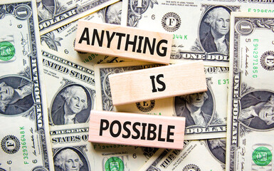 Anything is possible symbol. Concept words Anything is possible on beautiful wooden blocks. Dollar...