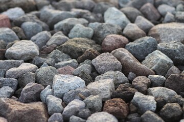Large stones of different shapes close-up. there are a lot of small stones nearby