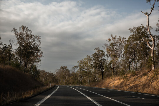 looking along an empty highway in afternoon light